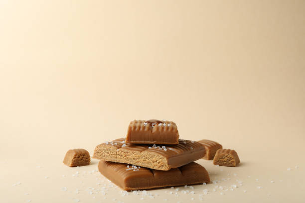 istock Salted caramel pieces on beige background, space for text 1310053917