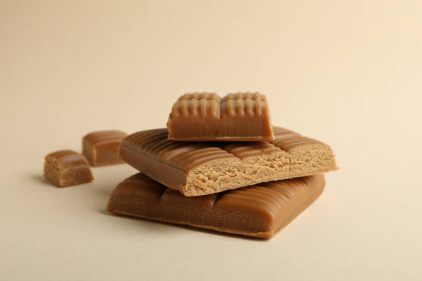 istock Caramel pieces on beige background, close up 1310054536