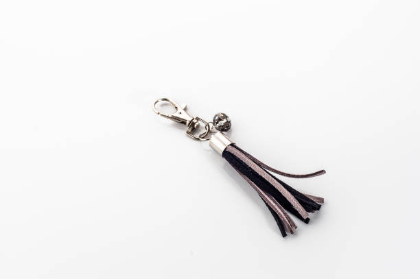 istock Fashionable key ring isolated on white, stylish boho jewelry 1310055006