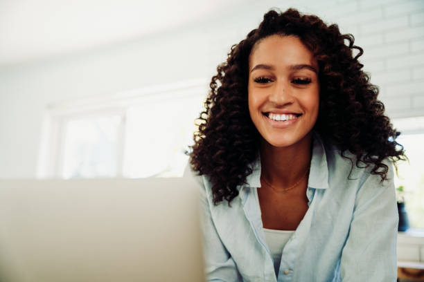 istock Mixed race female student working from home typing on laptop 1310055070