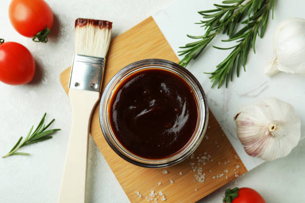 istock Concept of cooking with barbecue sauce on white textured table 1310055784