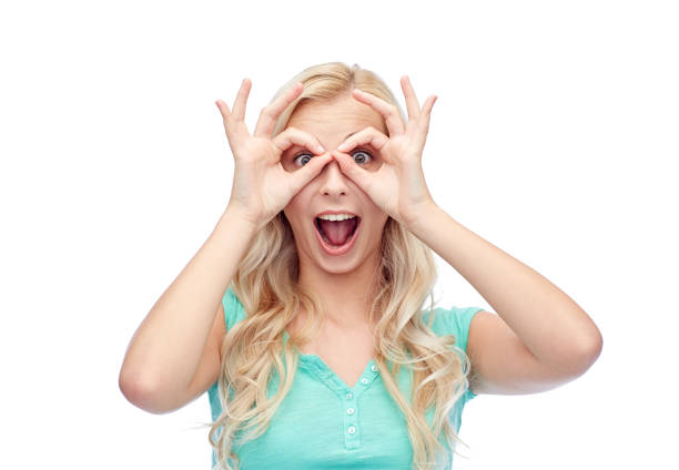 istock young woman looking through finger glasses 1310056287
