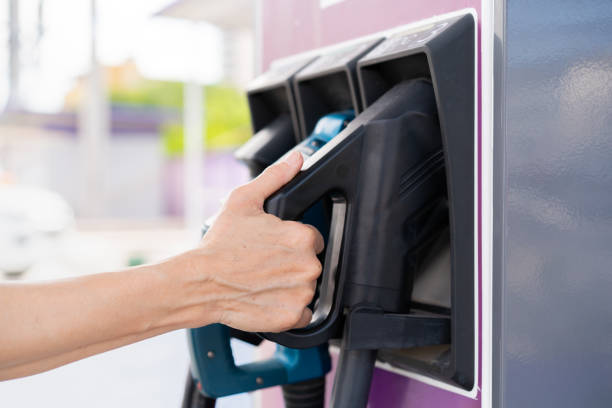 istock Woman picking up a EV Charger connector. 1310056325
