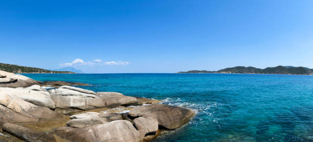 istock Beautiful seascape with stones and translucent blue water 1310056333