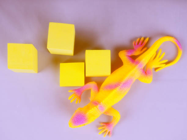 istock Toy blue dinosaur, lizard, iguana on a gray background 1310059153