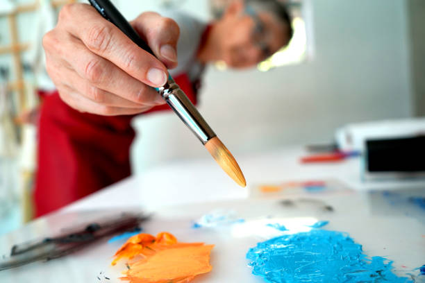 istock A woman artist painting in her studio 1310060704