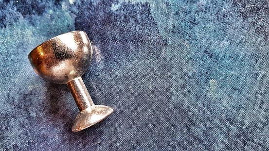 Silver goblet on blue background