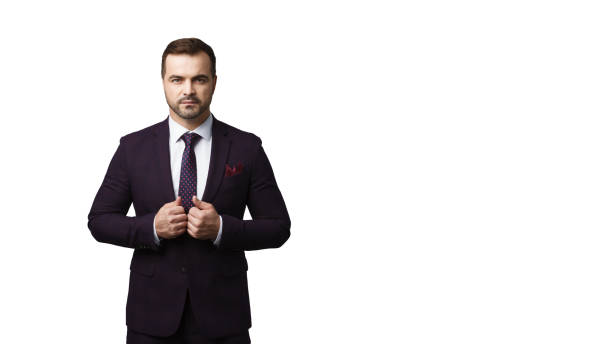 istock Handsome macho guy in dark suit standing isolated over white background 1310064088