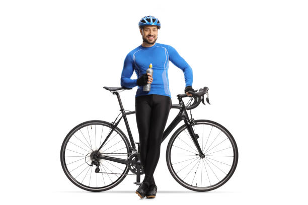 istock Male cyclist sitting on a bicycle with a bottle in his hands 1310064906
