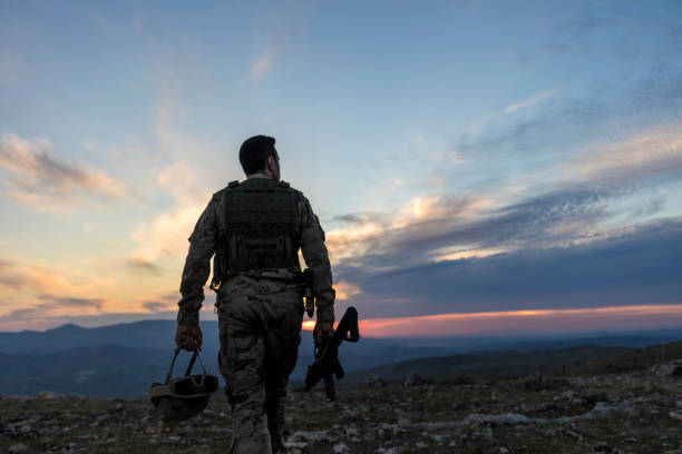 istock Army Soldier walking against sunset 1310065682