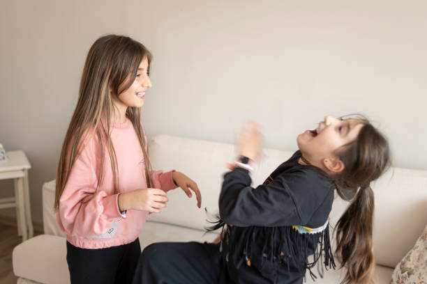 istock Beautiful sisters having fun at home 1310066499