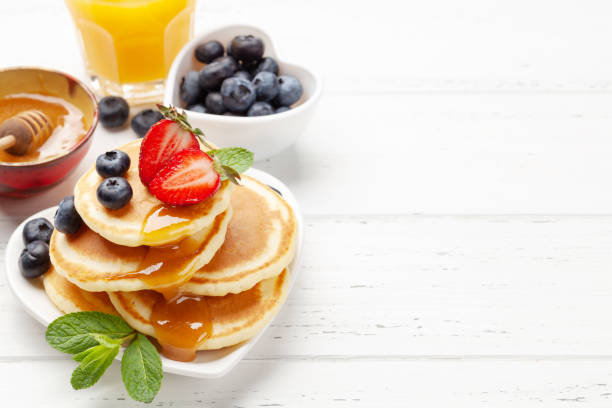 istock Healthy breakfast with pancakes and orange juice 1310066981