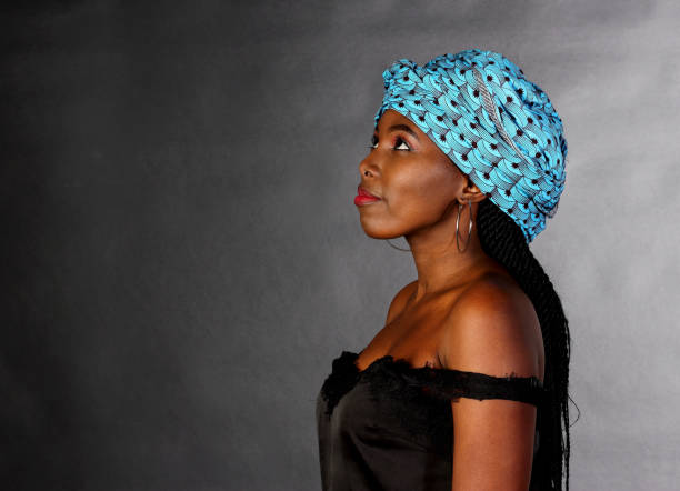 istock Black young girl in blue head scarf looking up 1310067099