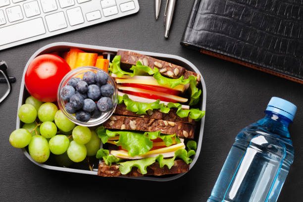 istock Healthy office lunch box with sandwich and fresh vegetables 1310067999