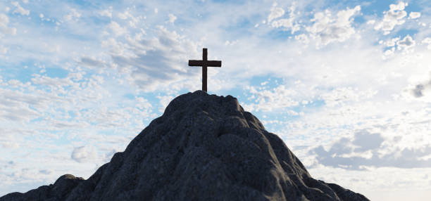 istock Cross on mountain peak at sunset christian religion 1310069164