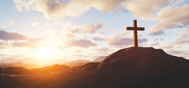 istock Cross on mountain peak at sunset christian religion 1310069181