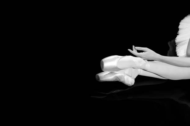 istock Classical ballet artist posing on a black background 1310069801