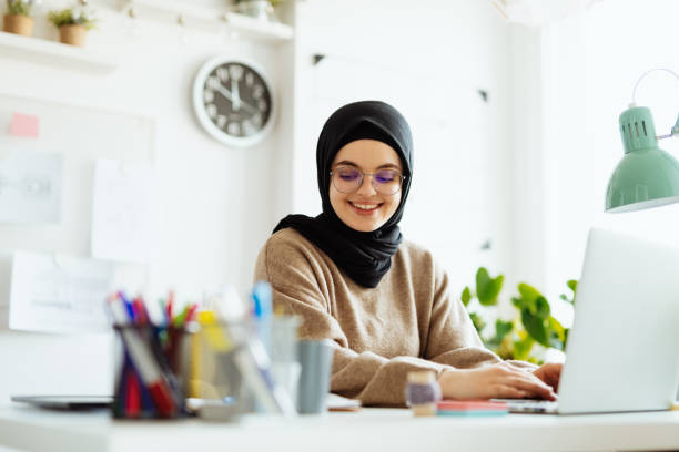 istock Middle Eastern woman working on laptop in office and using internet during online course 1310070568