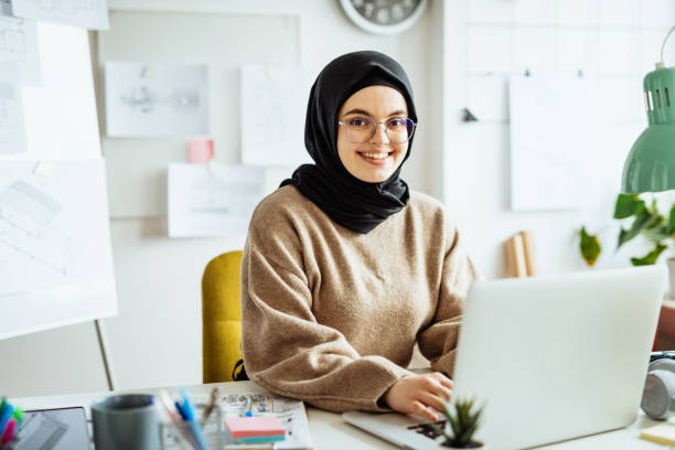 istock Middle Eastern woman working on laptop in office and using internet during online course 1310070610
