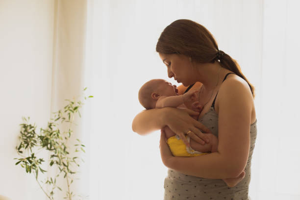 istock Mother Holding Crying Son At Home 1310070951