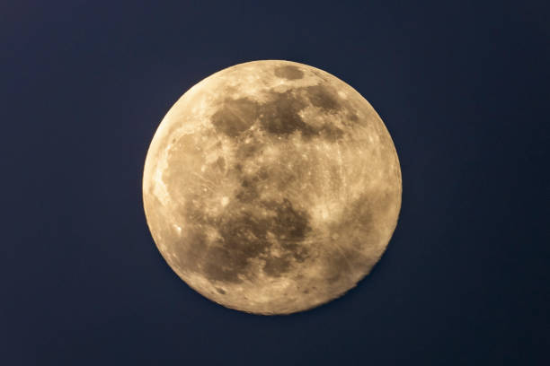 Full moon in the dark winter night with clearly visible moon surface during a weak partial eclipse stock photo