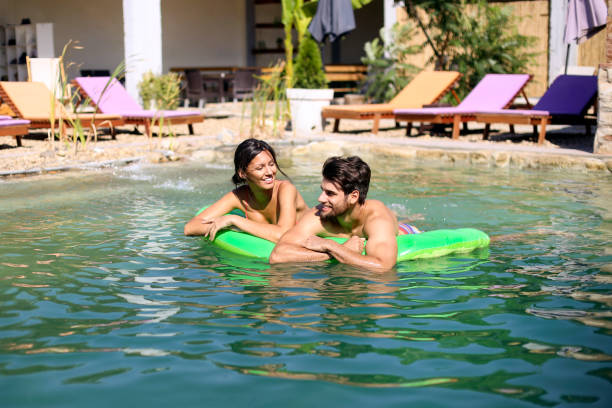 istock Young couple having fun at a pool 1310072464
