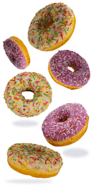 istock flying donuts isolated on white background. selective focus. set of multicolored crumpets. sweet doughnuts, traditional confectionery products. icing sugar with sprinkles. 1310074377