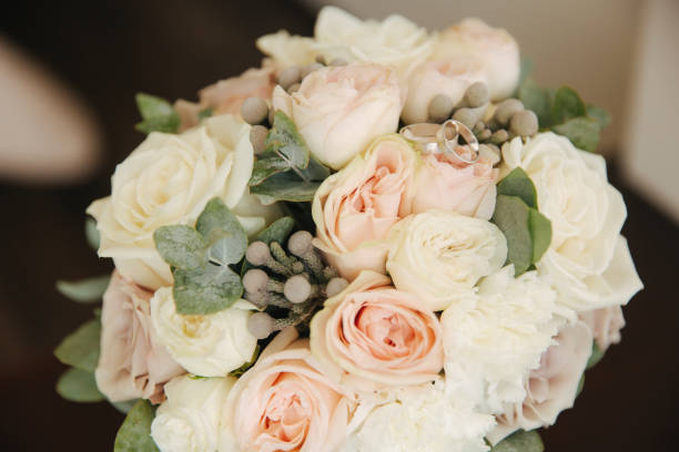 istock White gold rings on wedding bouquet. flowers 1310074414