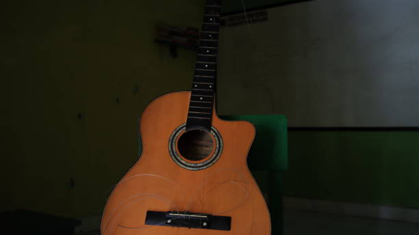 istock A damaged acoustic guitar, with the strings not attached, can't be plucked 1310076678