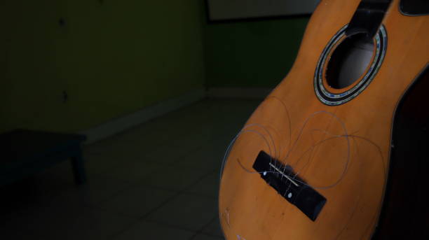 istock A damaged acoustic guitar, with the strings not attached, can't be plucked 1310076729