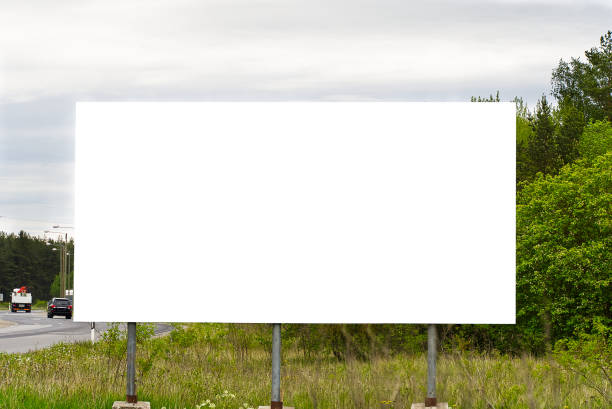 istock Empty white Billboard on a background of green nature. Suitable for advertising. Blank billboard and outdoor advertising. Mockup 1310078340