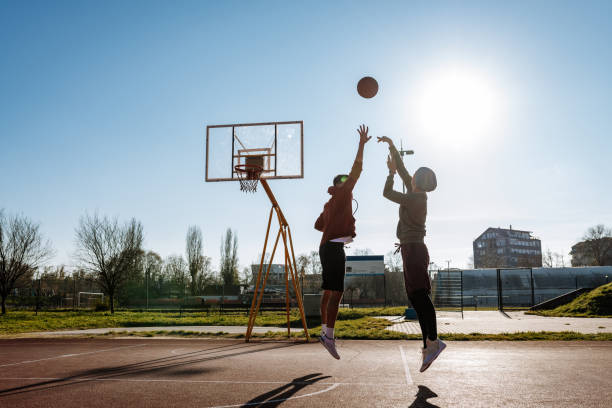 istock Millennials playing basketball outdoors in winter or autumn, unrecognisable faces 1310079530
