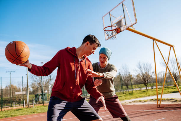 istock Millennials playing basketball outdoors in winter or autumn 1310079558