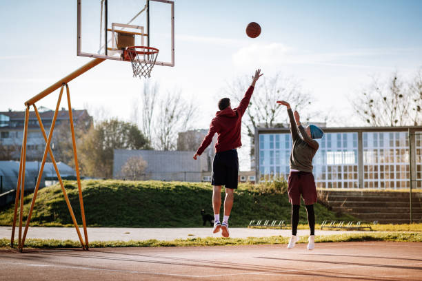istock Millennials playing basketball outdoors in winter or autumn 1310079564