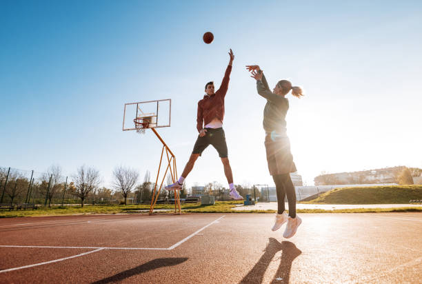 istock Millennials playing basketball outdoors in winter or autumn 1310079599