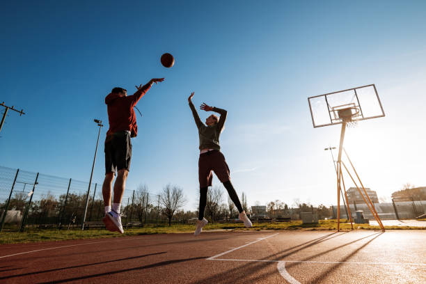 istock Millennials playing basketball outdoors in winter or autumn 1310079616