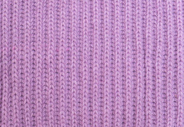istock Close-up texture of knitted fabric. Pink knitted background 1310079738