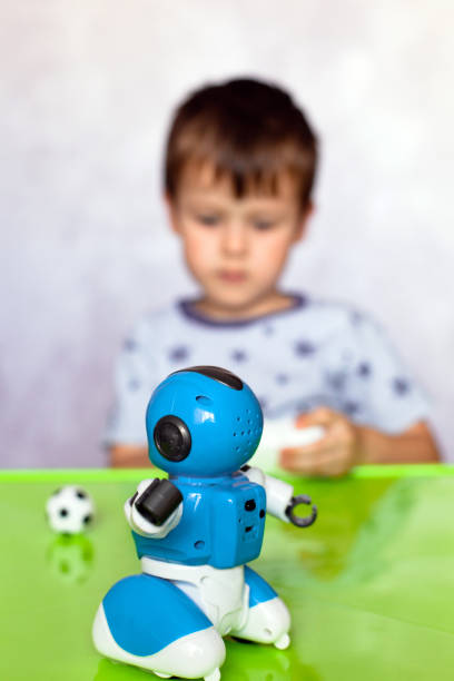 istock Little boy is playing with robot. Robot for children. Smart toy. Selective focus on toy robot 1310080639