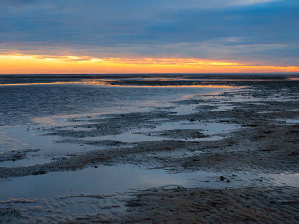 Sunset in the Lower Saxony Wadden Sea off Cuxhaven Sahlenburg at low tide, Germany stock photo