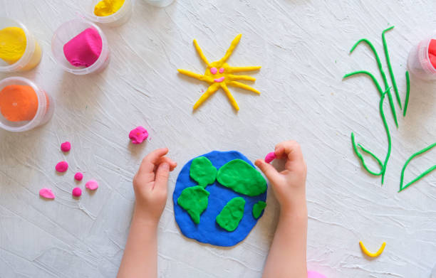 istock Child sculpturing plasticine planet for earth day. 1310083794
