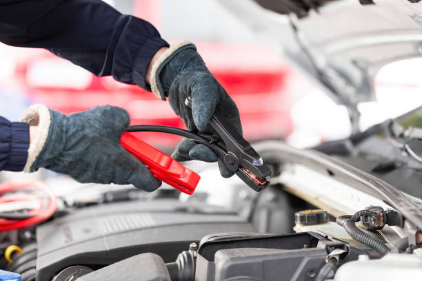 istock Human trying to start engine with jumper cables in close up 1310086163