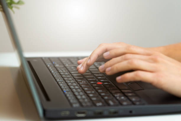istock Person working on computer in office space from close up 1310087259