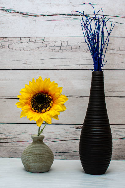 istock Stylish vases with fake sunflower 1310087958