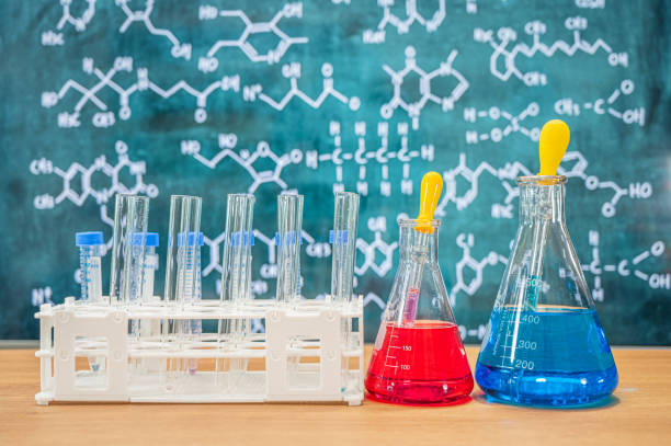 istock Laboratory glassware with blackboard background with various chemical formulas. 1310088612
