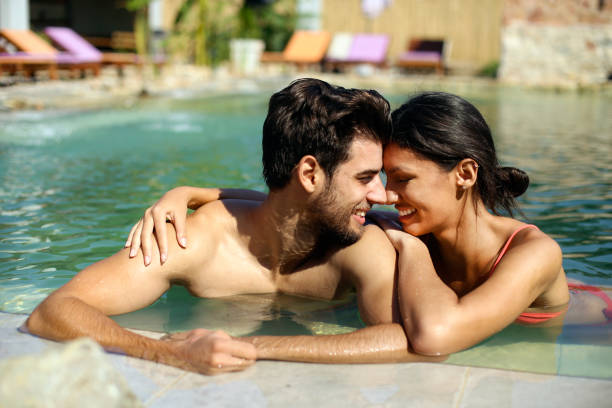 istock Young couple having fun at a pool 1310089940