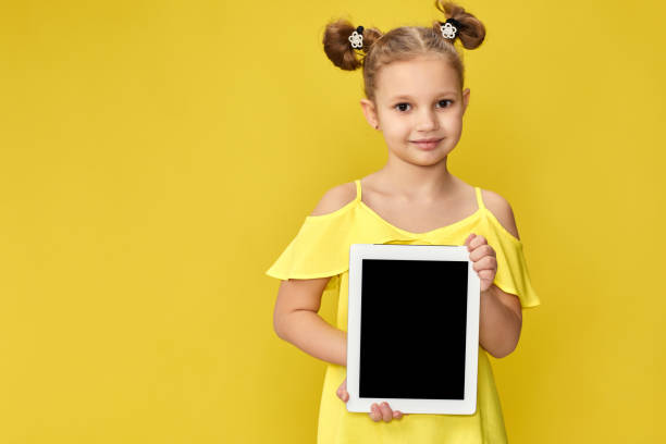 istock cute little child girl shows empty tablet 1310090906