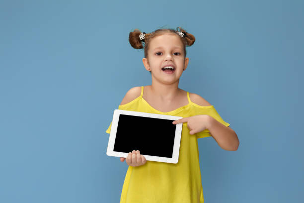 istock cute little child girl shows empty tablet 1310090985