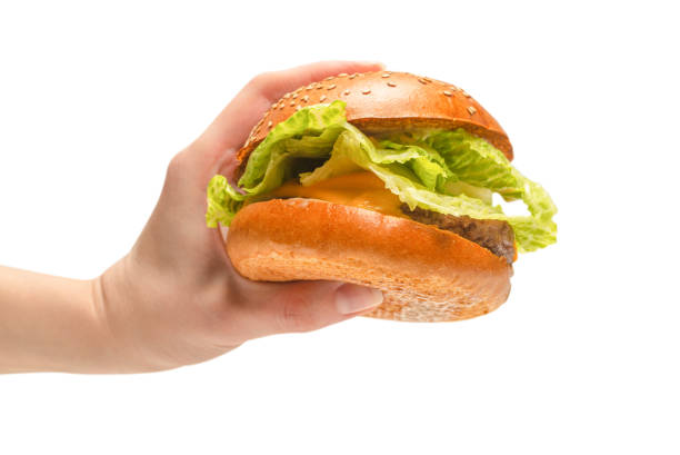 istock Hamburger in woman hands isolated on a white background. 1310091284