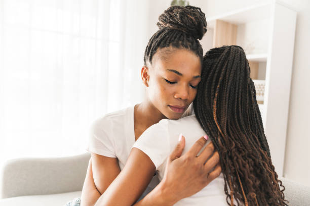 istock Mother and daughter consoling on sofa at home 1310093684