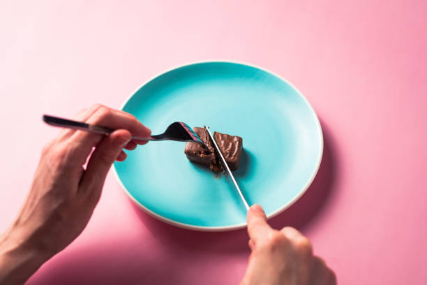 istock Person hands cut dessert on plate 1310093711